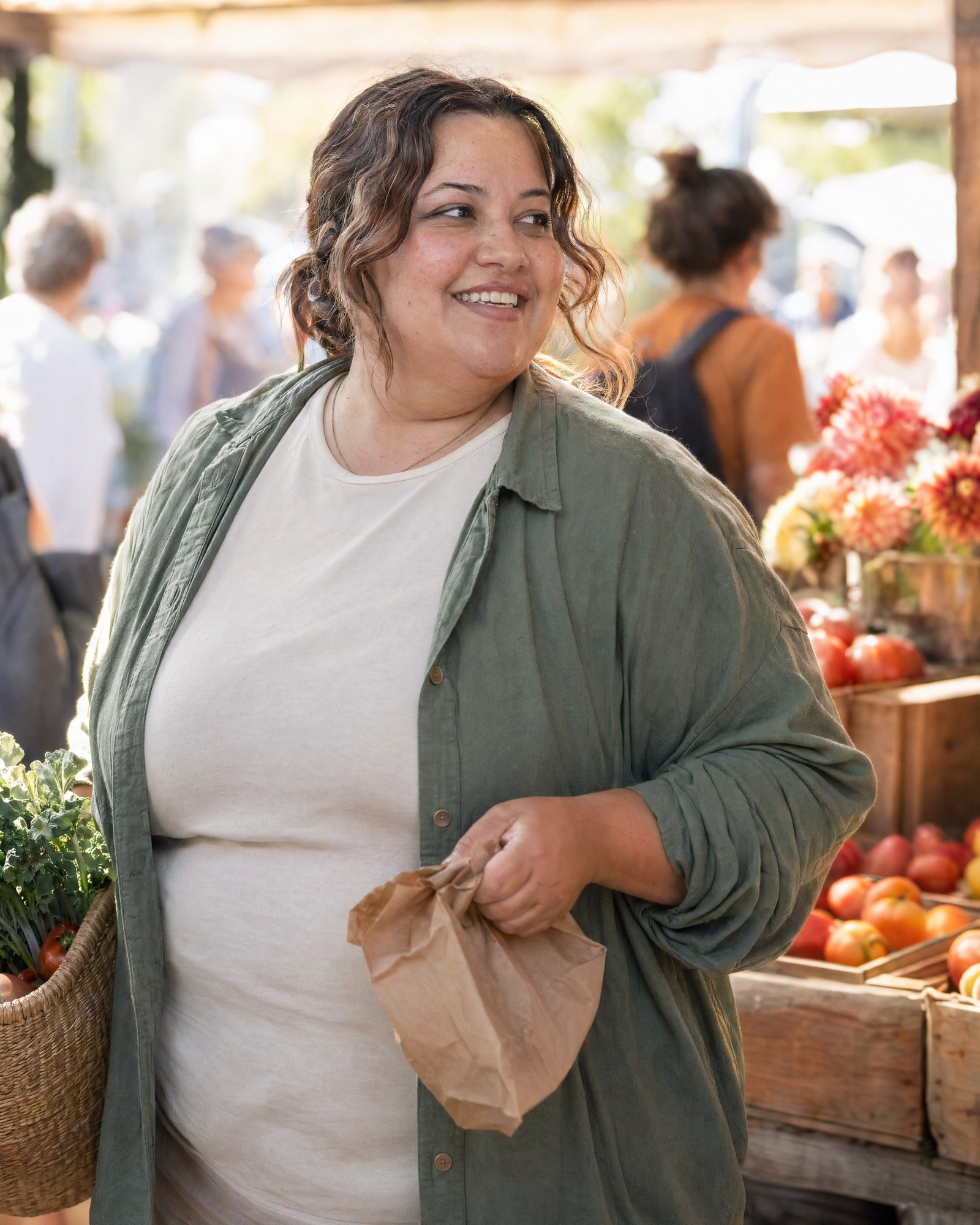 A woman walking through a sunlit farmers&rsquo; market in golden morning light